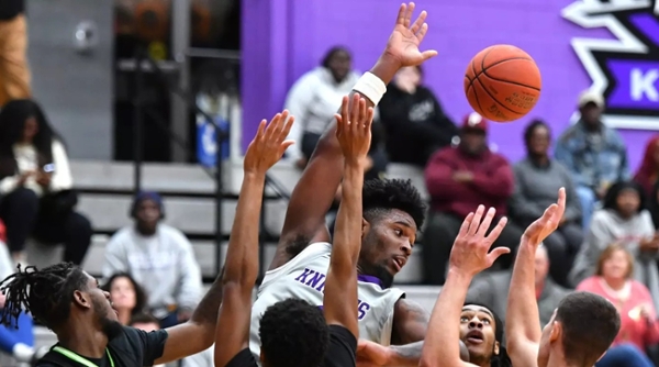 Knights men's basketball player handles the ball during a game.